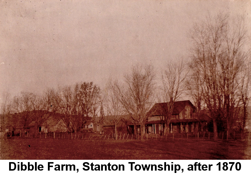 IMAGE/PHOTO: Dibble Farm, Stanton Township, after 1870: Rose-tinted photo of a two-story farmhouse grouped with several outbuildings and a windmill, surrouned by leafless trees, behing a leaning wire fence